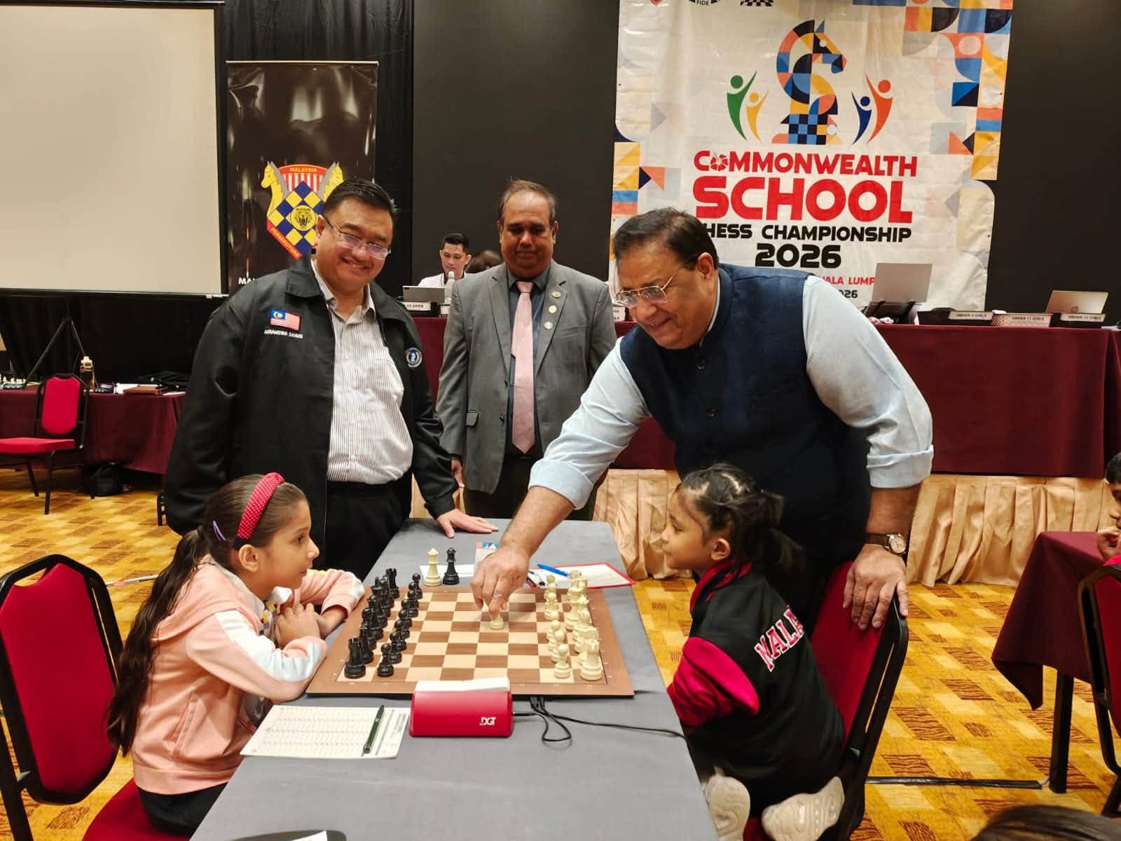 CCA Chairman Bharat Singh Chauhan makes the ceremonial first move, watched by Deputy Chairman Akhramsyah Muammar Ubaidah Sanusi, at the Commonwealth School Chess Championship 2026